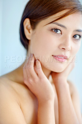 Buy stock photo Asian woman, portrait and touch for skincare, dermatology and beauty in studio with healthy skin. Female person, face and hygiene routine on blue background for facial treatment, self care and glow