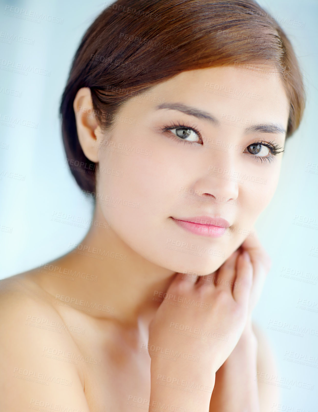 Buy stock photo Asian woman, face and touch for skincare, dermatology and beauty in studio with healthy skin. Female person, portrait and hygiene routine on blue background for facial treatment, self care and glow