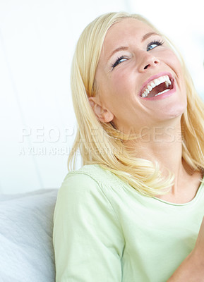 Buy stock photo An attractive young woman laughing and smiling while looking away