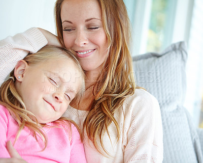 Buy stock photo Relax, woman and happy with hug of kid for weekend, appreciation or gratitude in motherhood. Home, cuddle and smile of mom with girl on sofa for family safety, love or connection in child development