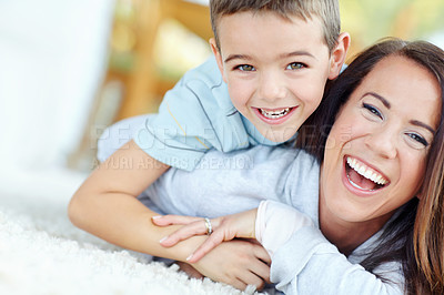 Buy stock photo Happy, portrait and mother with child for relax, bonding or playing together on floor at home. Smile, laugh and boy kid laying on mom for fun, connection and love on carpet at family house together.