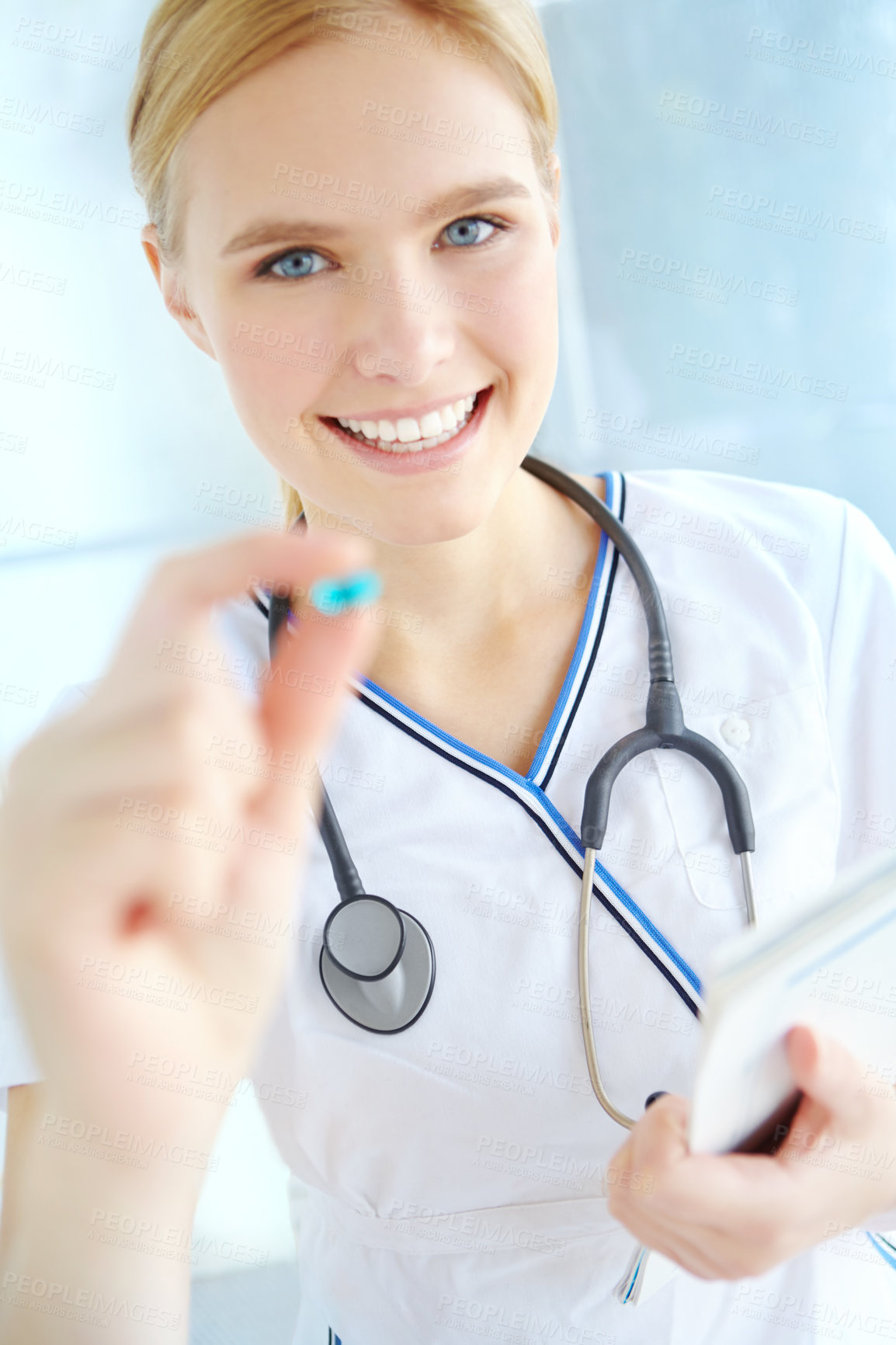 Buy stock photo Nurse, portrait and woman with pill at hospital for healthcare, support or pharmaceutical drug. Happy, professional and person with paper at clinic for medical checklist, prescription and information