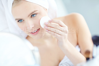 Buy stock photo Skincare, woman and cleaning face with cotton pad for facial hygiene, wipe makeup and dermatology treatment. Girl, product and cosmetic for natural benefits, glow results and beauty mirror at house