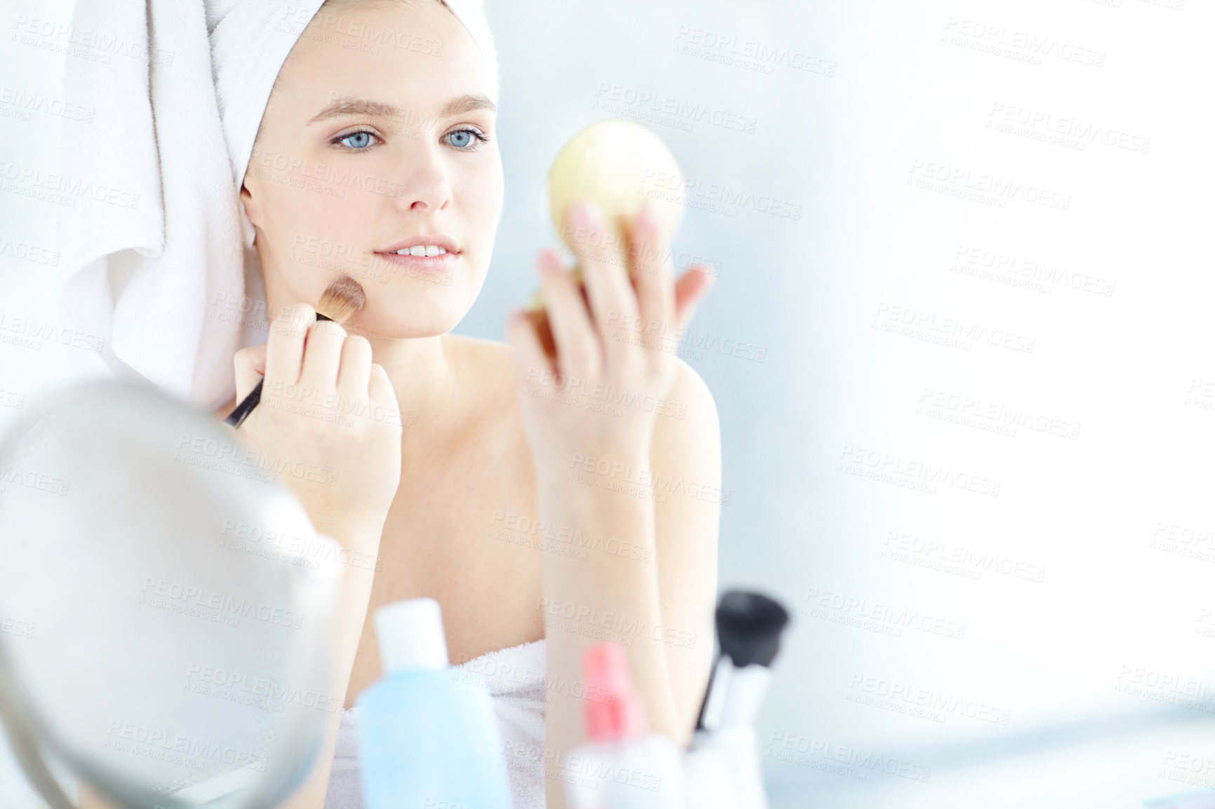 Buy stock photo Makeup, brush and woman with hand mirror in home for facial, beauty and cosmetic treatment. Cosmetology tool, self care and female person getting ready with press powder for smooth skin at house.