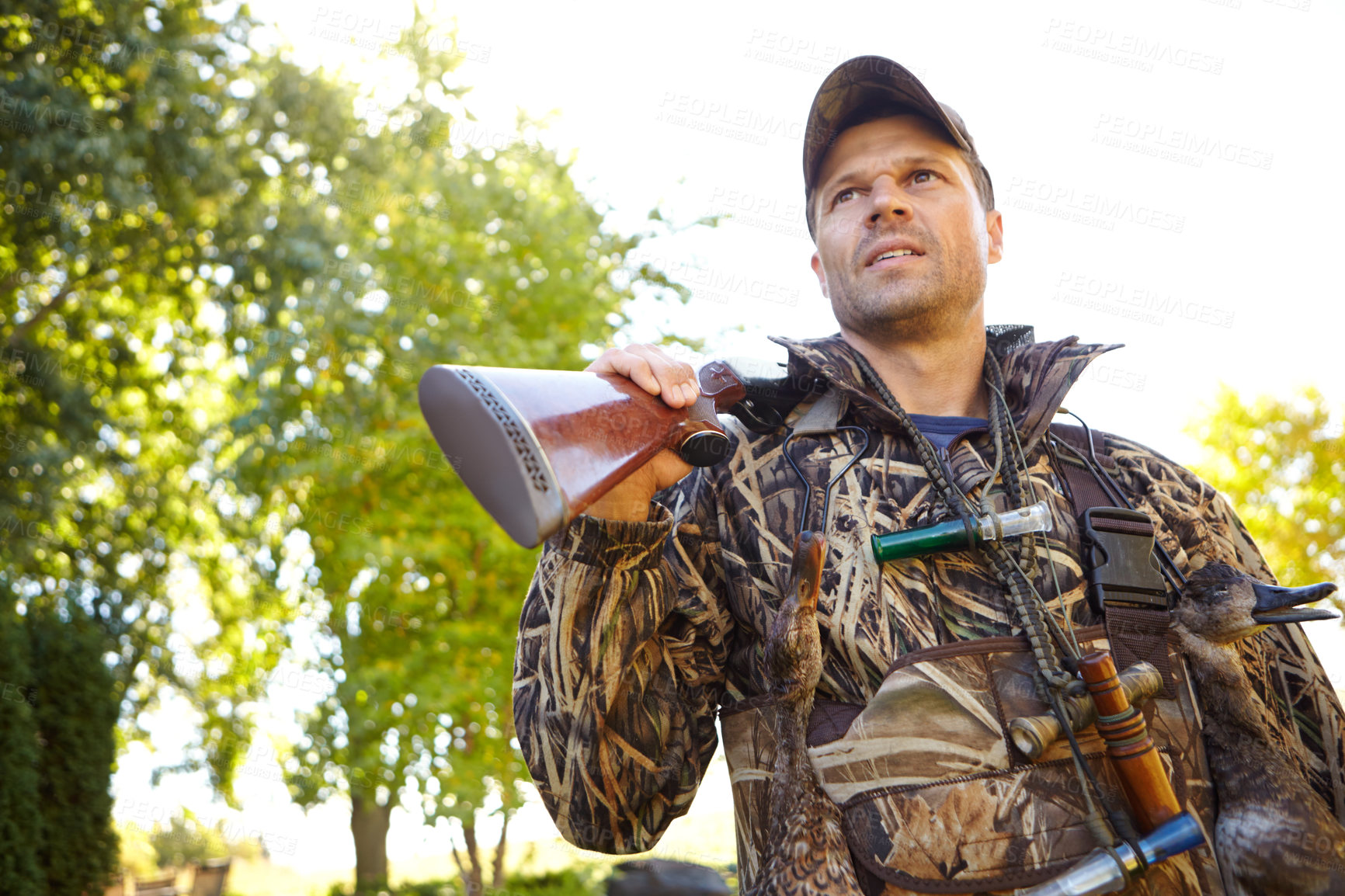 Buy stock photo Hunter, man and gun with gear outdoor for camouflage, hunting wildlife or adventure activity of nature safety. Male person, rifle and security for thinking, planning ideas and woods danger of process