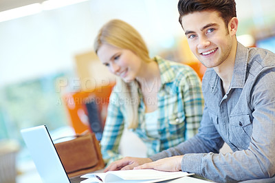 Buy stock photo Education, laptop and portrait of student man in library at college or university campus for learning. Computer, development and online study with happy person at school desk or table for scholarship