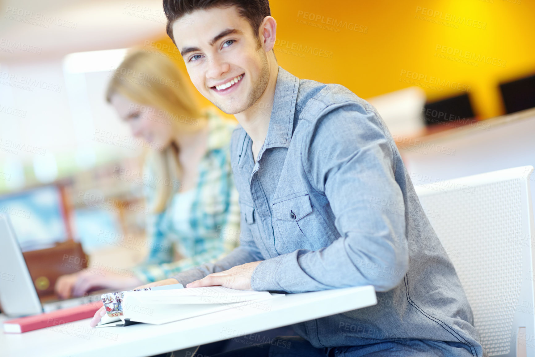 Buy stock photo Education, book and man in library for portrait, learning and studying at table. Happy student, textbook and information in college for exam preparation, reading or research subject for knowledge