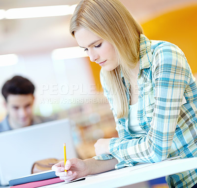 Buy stock photo Girl, reading and writing in notebook or classroom for study group, project or assignment. Female person, desk and pencil for education, course or learning in college, campus or university as student