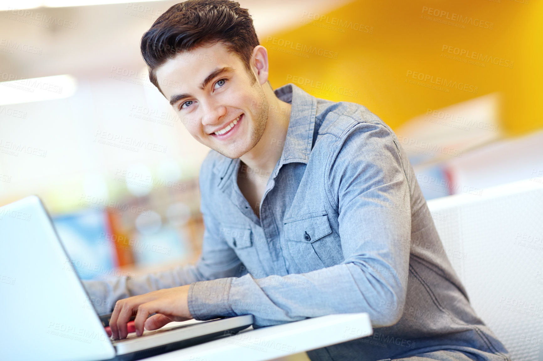 Buy stock photo Education, laptop and portrait with student man in library on campus of college or university for development. Computer, smile and typing with happy person at desk or table for reading or research