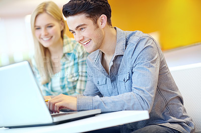 Buy stock photo Education, laptop and reading with student friends in library on campus of college or university for development. Computer, smile and study with happy people at desk or table for research or typing