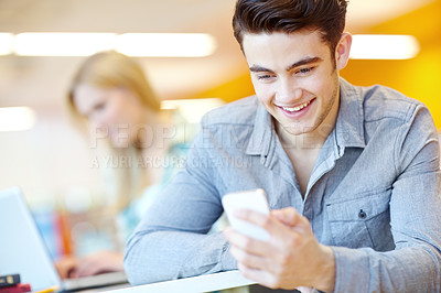 Buy stock photo Typing, student and man in library, smartphone and happy with connection, text and message. Joy, people or guy with cellphone, university or digital app for exam results, education or online reading