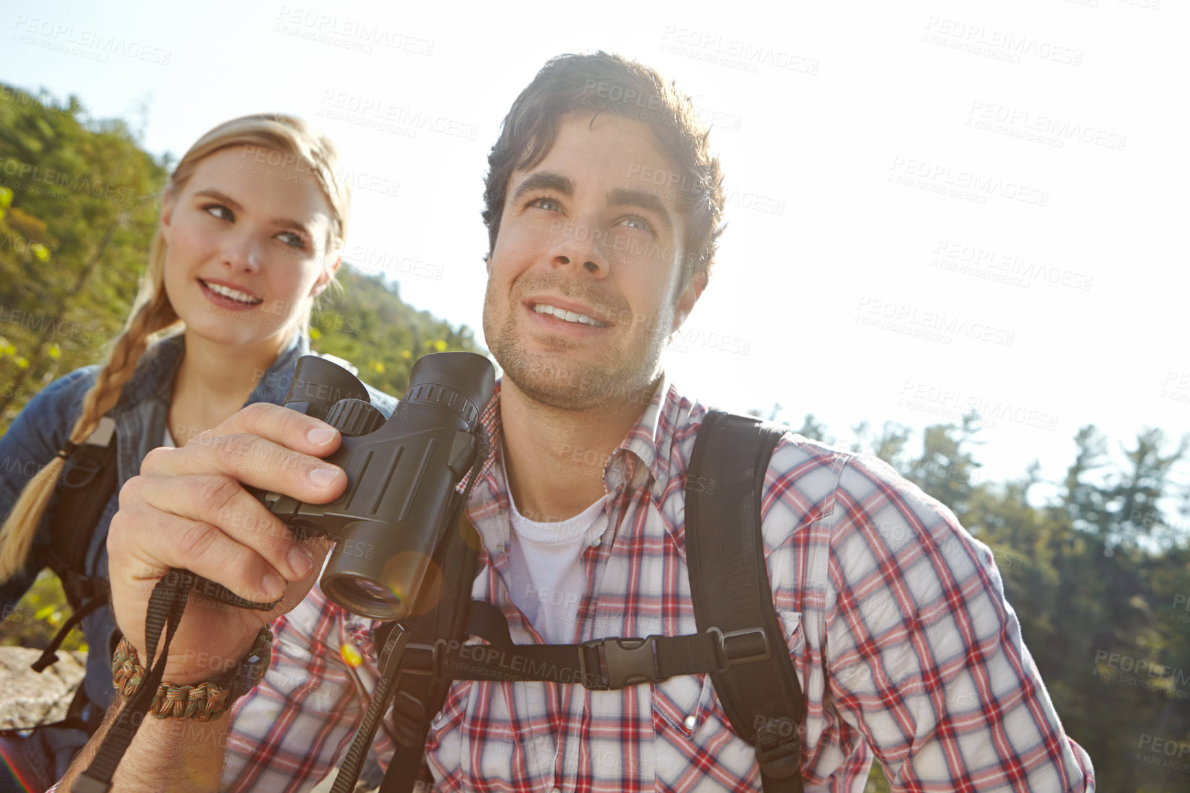 Buy stock photo Looking, binocular or happy couple in forest or mountain for travel and outdoor adventure in park. View, hiking and people sightseeing together on holiday vacation, trip or break to explore woods