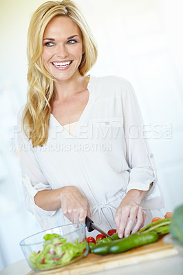 Buy stock photo Woman, happy and cut vegetable in kitchen for healthy salad, meal prep and weight loss with hydration. Female person, thinking and cucumber in house for nutrition, gut health and diet food with knife