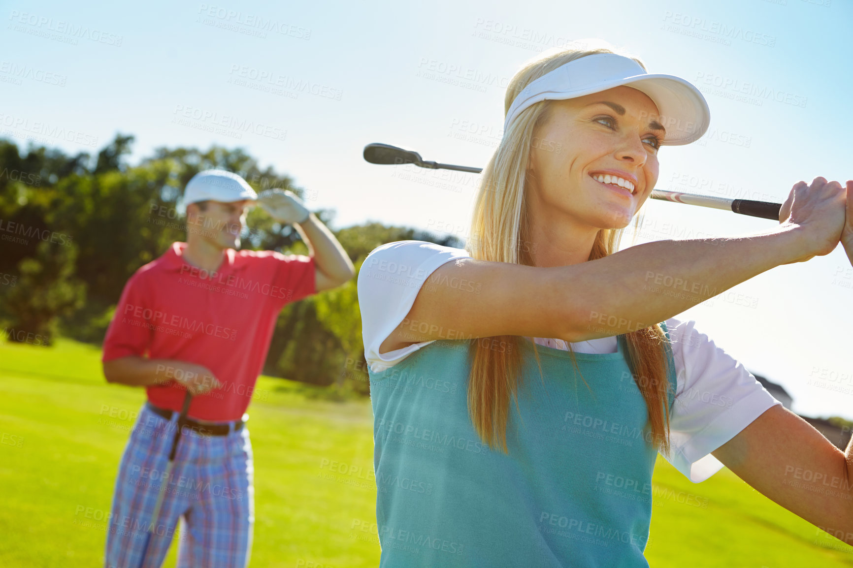 Buy stock photo Golf course, woman and man with smile, swing and outdoor fun for fitness challenge on weekend morning. Confidence, team and happy couple on green for sports date, health and wellness with partnership