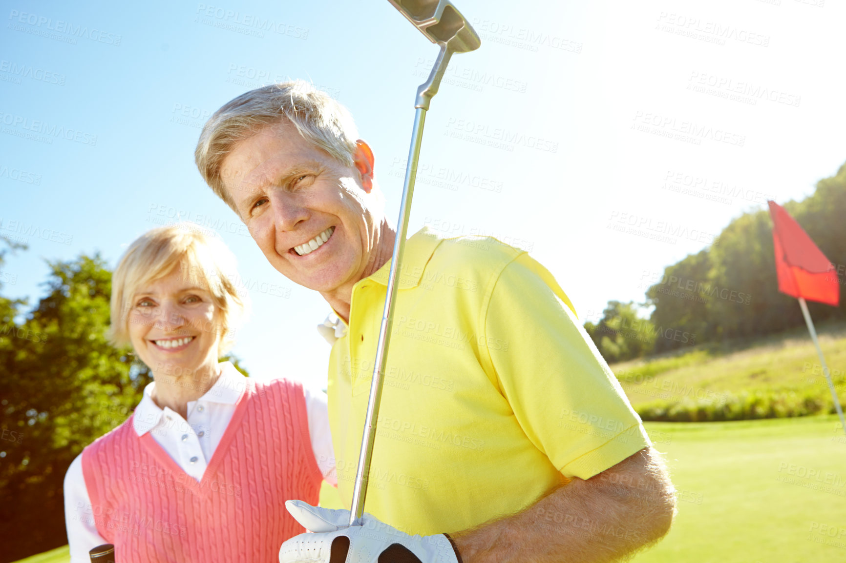 Buy stock photo Senior, portrait and happy couple with golf club for sports, game or friendly outdoor match together on grass field. Mature man, woman or golfers with smile for challenge, fitness or play in nature