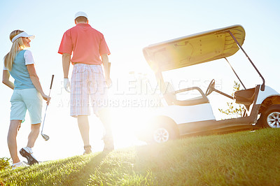 Buy stock photo Sports, golf course and back of couple for game, match and competition on field for activity. Morning, hobby and man and woman for playing, fun and practice together to relax, bonding and sun flare