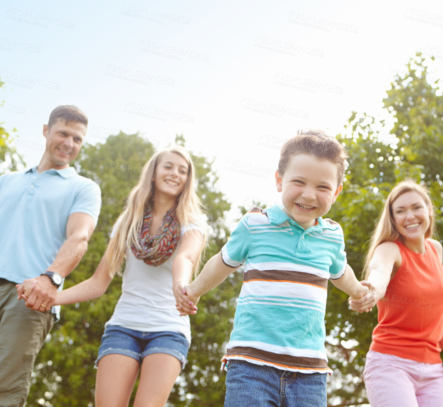 Buy stock photo Child, family and holding hands in nature for portrait, trust and fun activity on adventure in Australia. Parents, children and excited boy in park for game, playful and energy on holiday or vacation