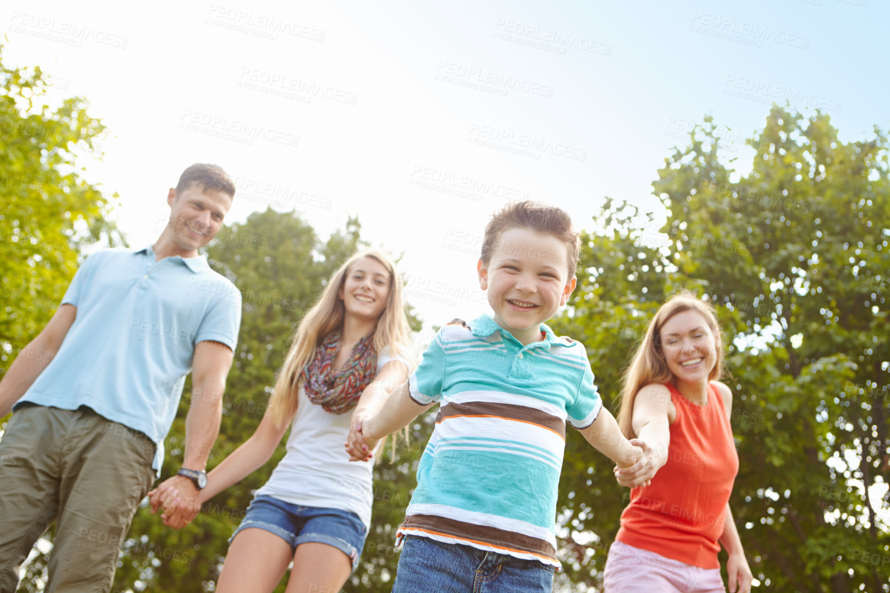 Buy stock photo Kid, family and holding hands in nature for portrait, trust and fun activity on adventure in Australia. Parents, children and excited boy in park for game, playful and energy on holiday or vacation