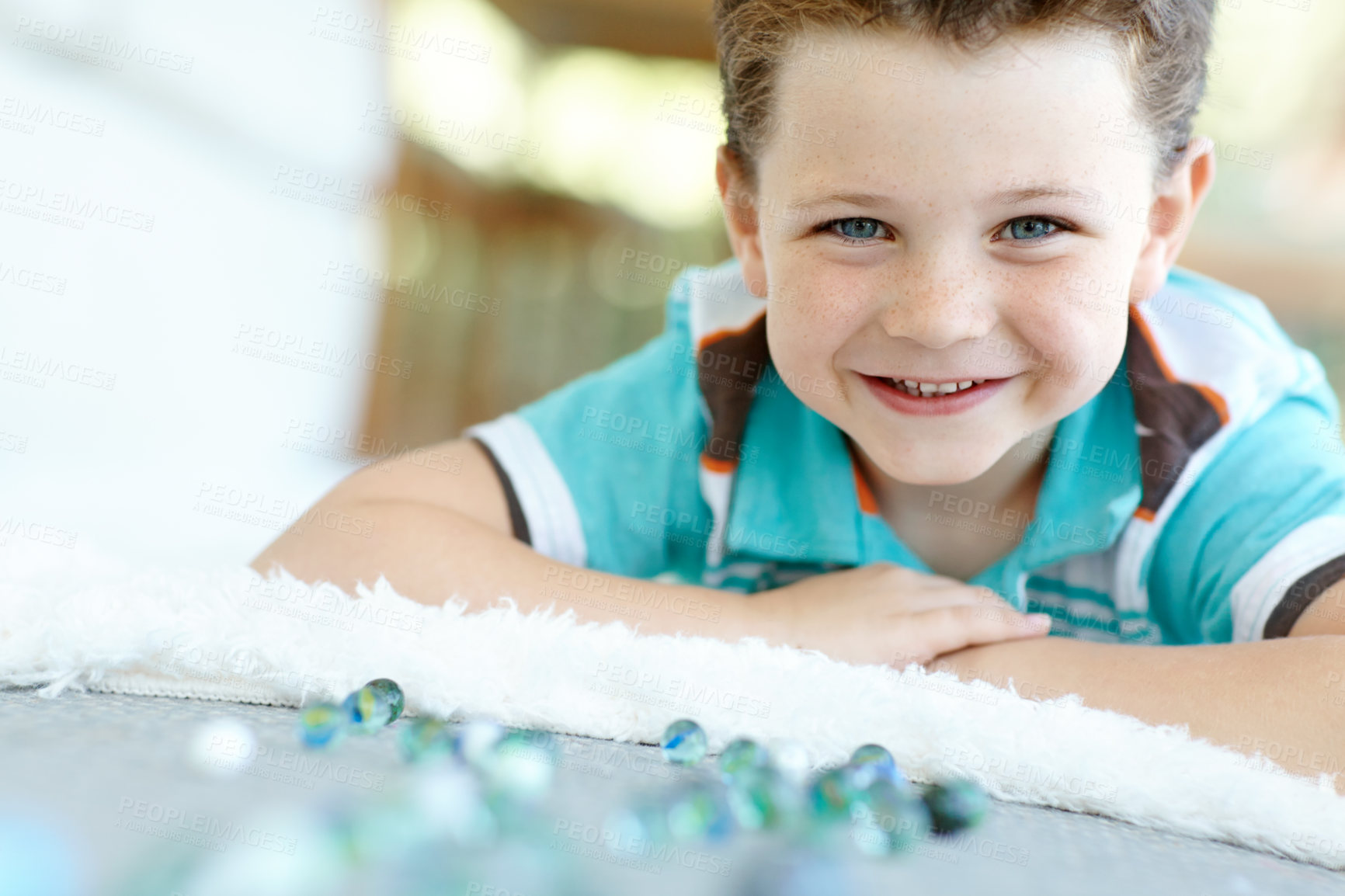 Buy stock photo Happy child, portrait and boy play with marble on floor for game, relax and fun in home. Smile, face and kid with glass balls or toys on ground for creative collection or childhood development in Uk