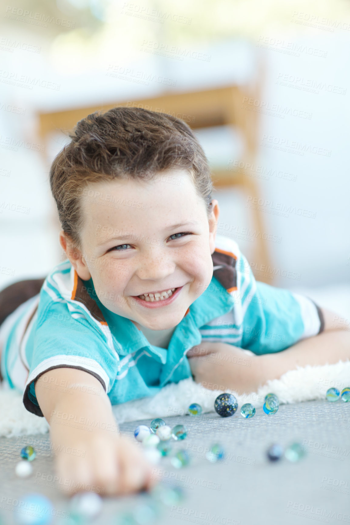 Buy stock photo Smile, portrait and kid play with marbles on floor for game or relax in home. Face, happy boy and cute child with glass balls or toys on carpet for creative collection, learning or development in USA