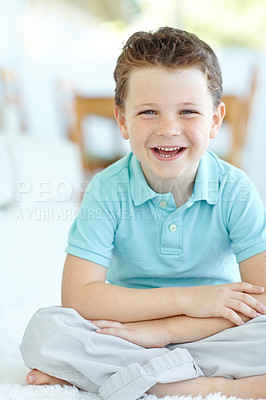 Buy stock photo Boy, happy child and laughing in home portrait, morning confidence and chilling on floor of living room. Male person, kid and funny joke on carpet in France, healthy growth and development in lounge