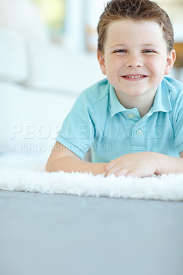 Buy stock photo Boy, happy child and calm in home portrait, morning confidence and chilling on floor of living room. Male person, kid and mockup space on carpet in France, healthy growth and development in lounge