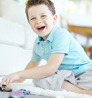 Buy stock photo Floor, boy and happy with toy cars on portrait for fun on school break at home in Scotland. Male person, kid and smile at apartment with playing for child growth, care and brain development at lounge