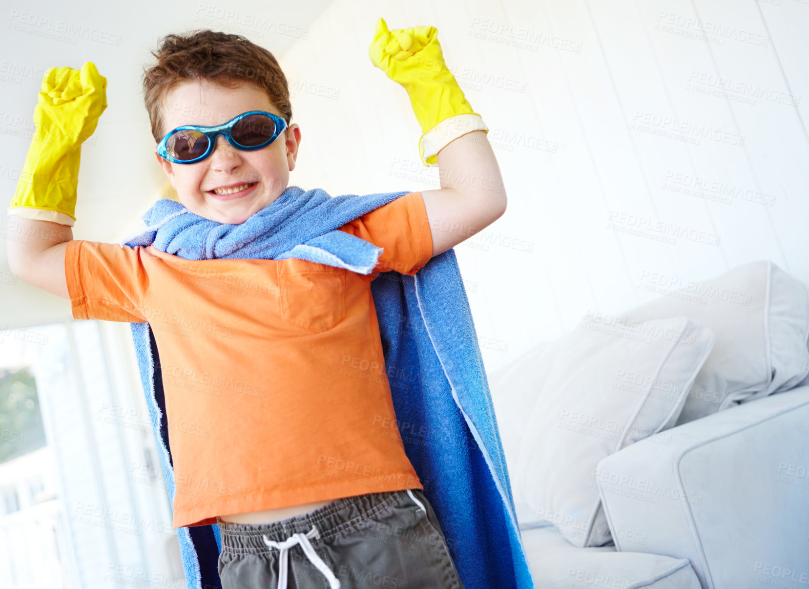 Buy stock photo Strong, kid and happy superhero in home to play fantasy game on halloween. Smile, cute boy and hero with power in costume to fight for justice, courage or flex muscle for creative cosplay in lounge