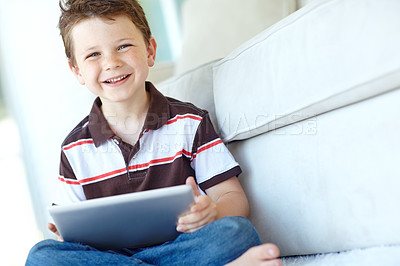 Buy stock photo Portrait, tablet and happy child relax in home for learning on living room floor. Boy, kid and digital technology for internet addiction, scroll app or playing game for education on carpet in Germany