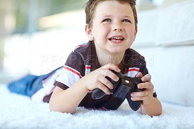 Buy stock photo Home, child and smile with controller for video game, playful and entertainment for childhood by carpet. Living room, happy boy and gamer with equipment for navigation, character action and challenge