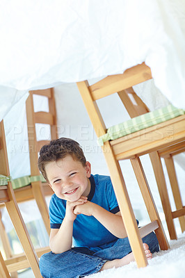 Buy stock photo Boy, kid and fort in home portrait, playing hide and seek on floor of living room. Male person, child imagine and camping tent for games on carpet in France, healthy growth and development in lounge