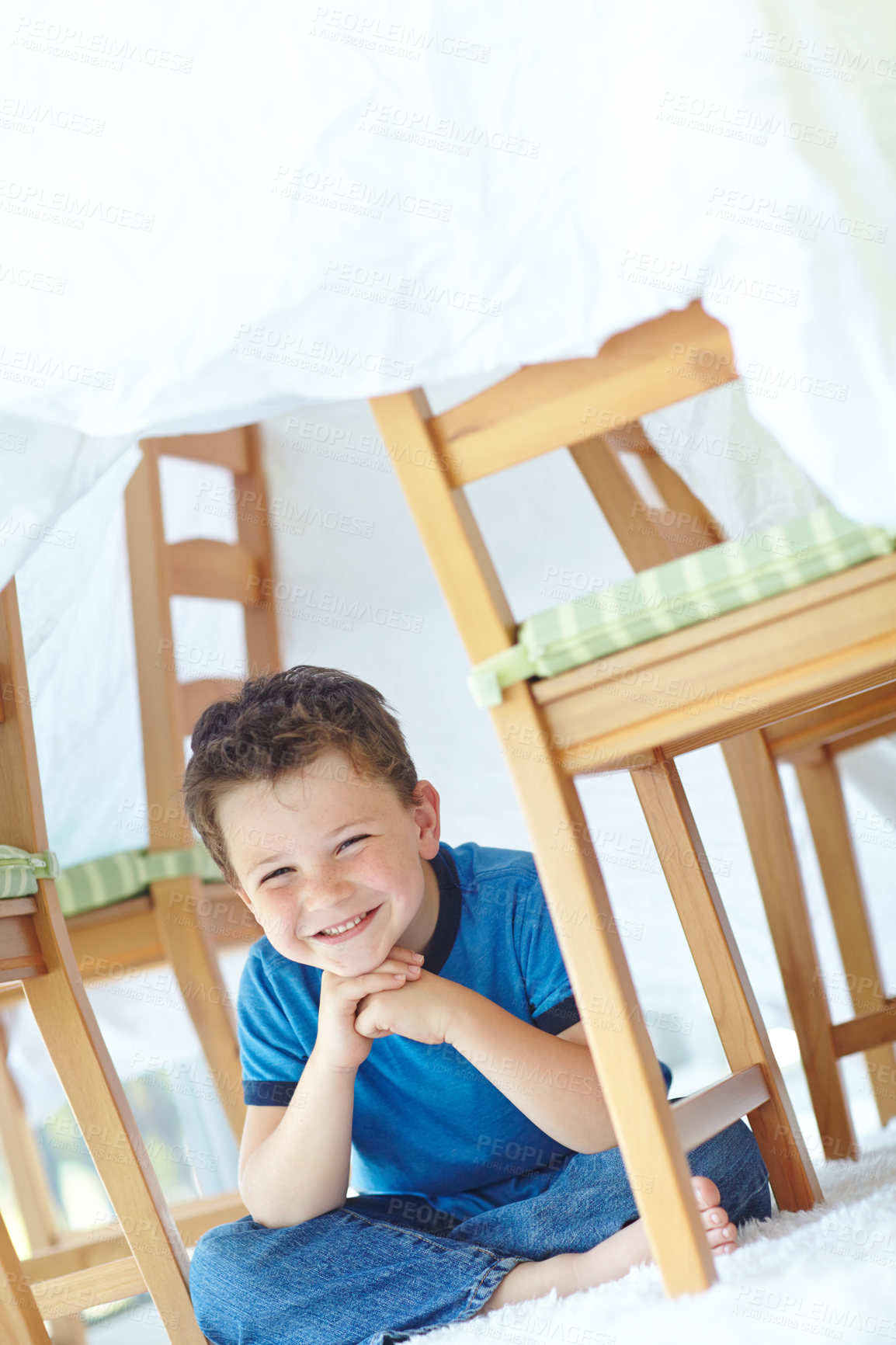 Buy stock photo Boy, kid and fort in home portrait, playing hide and seek on floor of living room. Male person, child imagine and camping tent for games on carpet in France, healthy growth and development in lounge