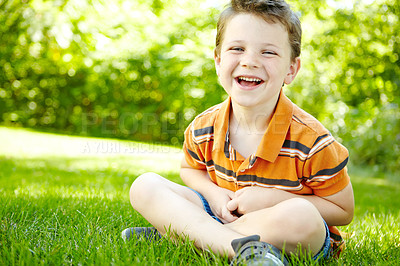 Buy stock photo Boy, outdoor portrait and child laughing on grass, forest adventure and countryside for development. Male person, happy kid and travel to France for joke, relax and healthy growth in environment