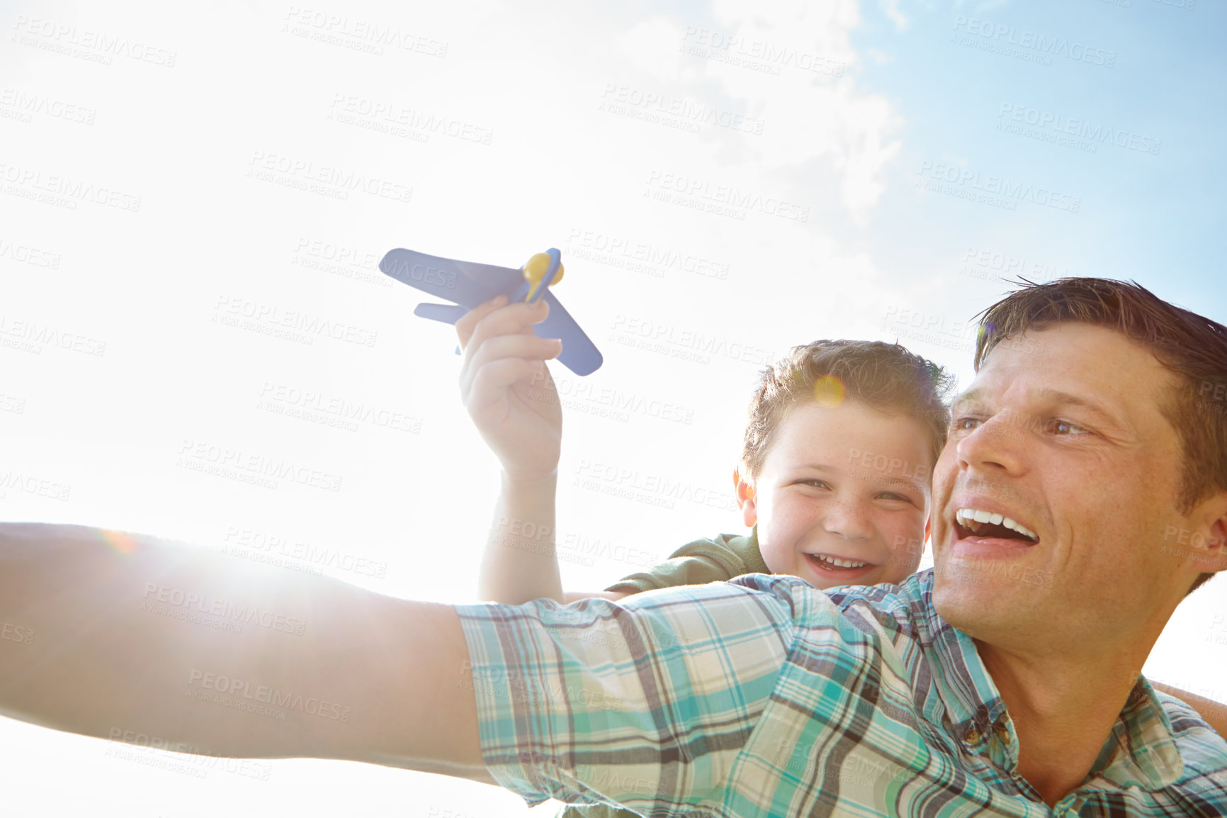 Buy stock photo Laughing, piggyback or plane with father and son outdoor together for bonding or having fun. Face, funny or sky with single parent man and boy child playing for fantasy, flying or love in summer