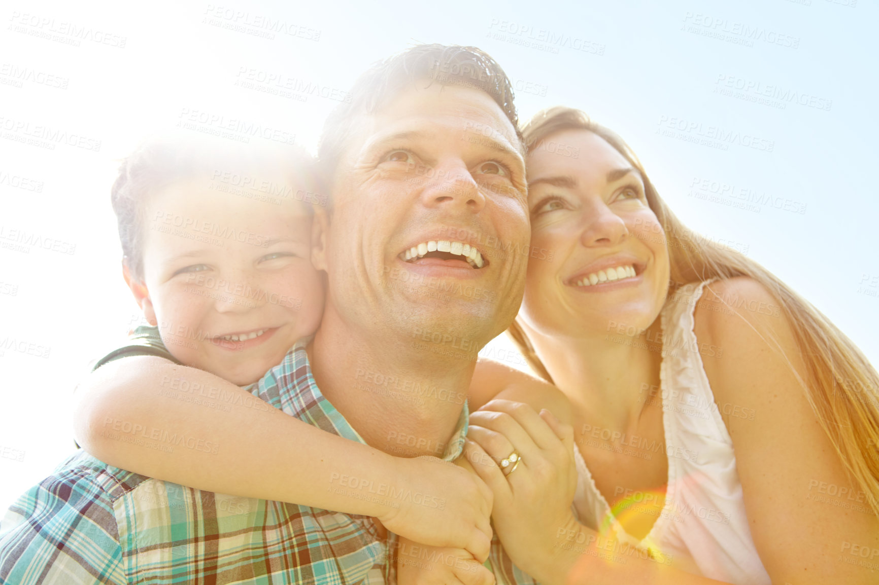 Buy stock photo A cute young family spending time together outdoors on a summer's day