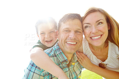 Buy stock photo A cute young family spending time together outdoors on a summer's day