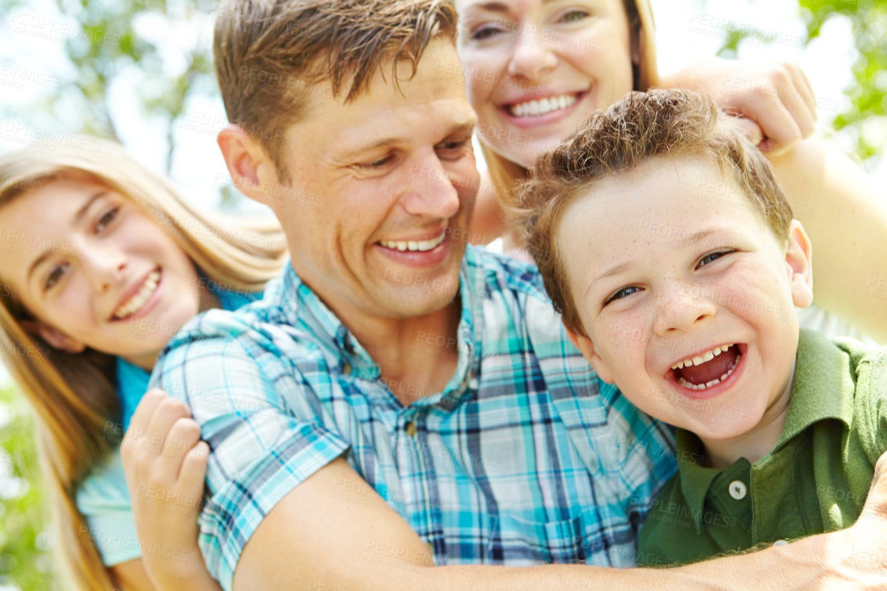 Buy stock photo Portrait, family and bonding with hug, love and parents with children, outdoor and embrace in nature. Happy, woman and man with kids, together and relax in weekend, fun and break in park and youth