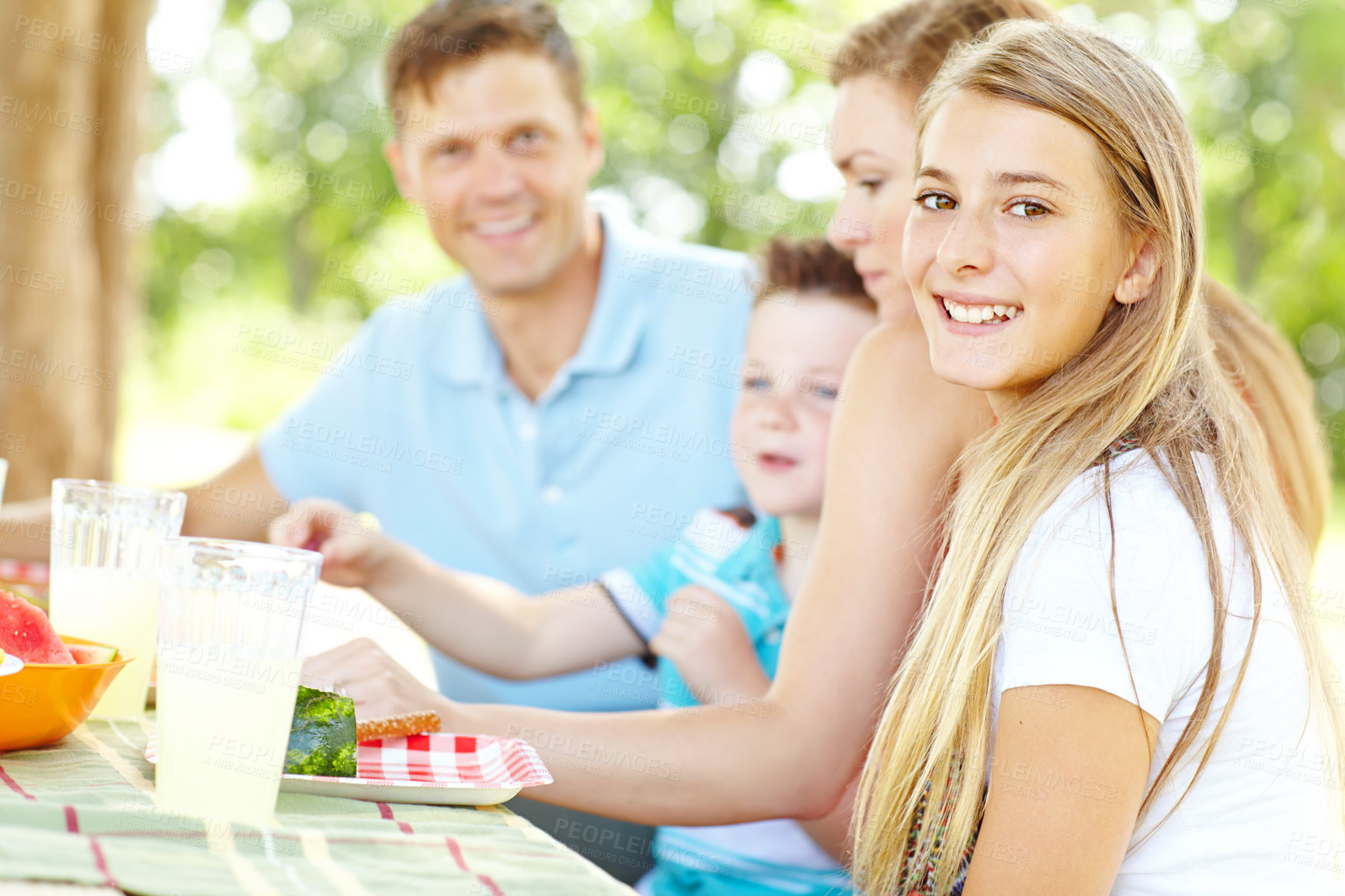 Buy stock photo Portrait, happy family and girl at picnic with food for party and eating for thanksgiving. Smile, lunch and people together outdoor with mother, father and kids for celebration at social gathering