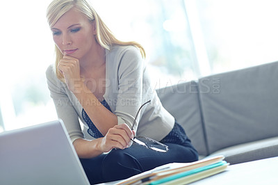 Buy stock photo Shot of a beautiful business woman looking at her laptop with copyspace