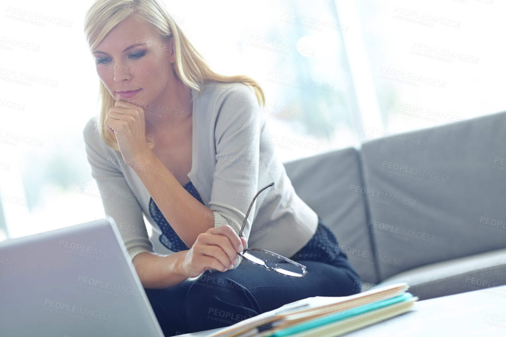 Buy stock photo Shot of a beautiful business woman looking at her laptop with copyspace