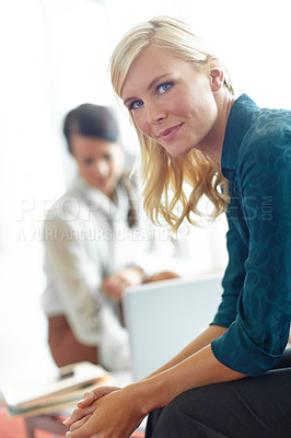 Buy stock photo Portrait of a beautiful blonde woman sitting in an office environment
