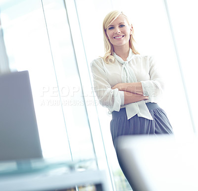 Buy stock photo Portrait of a confident business woman smiling at the camera with her arms folded with copyspace