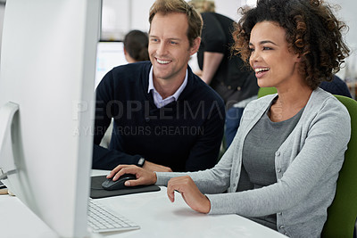 Buy stock photo Male and female coworkers working positively on a project together