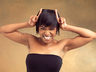 Buy stock photo Gesture, horns or portrait of girl with hair care in studio for keratin growth, healthy shine or beauty. Devil hands, smile or face of happy black woman with style or natural glow on brown background