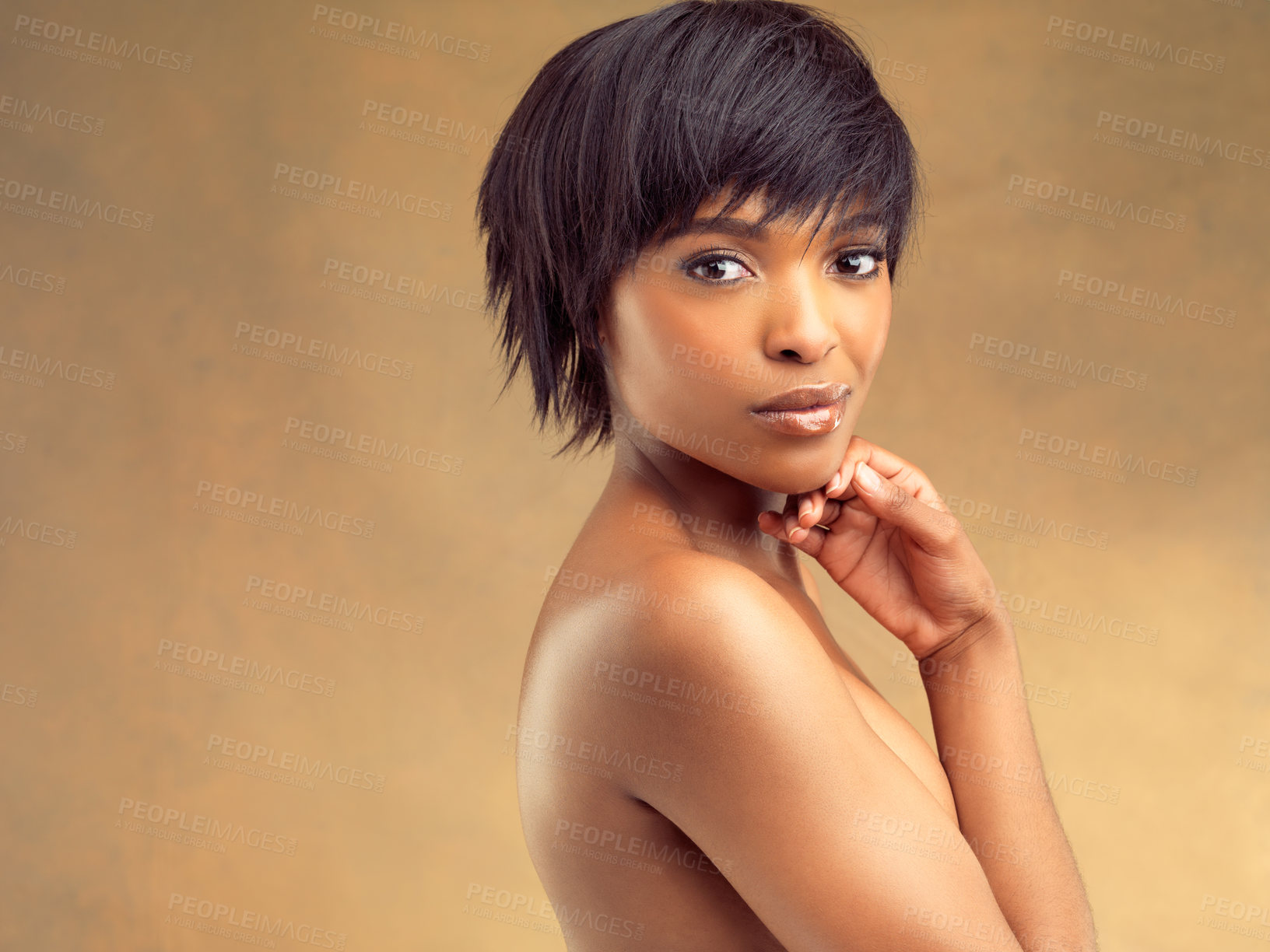 Buy stock photo Studio shot of a beautiful young woman against a brown background