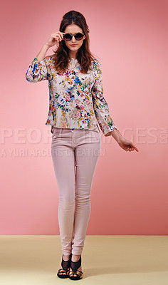 Buy stock photo Full length shot of an attractive young woman wearing designer shades against a pink background