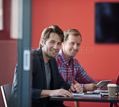 Buy stock photo Portrait of two coworkers colleagues sitting at a table in a boardroom