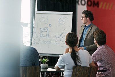 Buy stock photo Shot of a man giving a presentation to colleagues in a boardroom