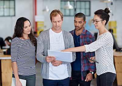 Buy stock photo Cropped shot of a group of creative businesspeople discussing something together in the office