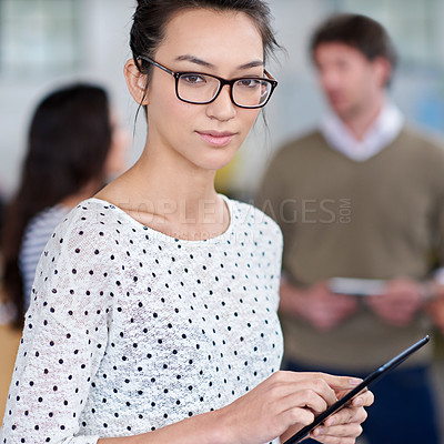 Buy stock photo Cropped portrait of a young woman in an office holding a digital tablet